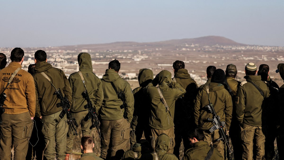 Israeli soldiers look into Syria, after the ousting of Syria&#039;s Bashar Assad, in Ein Zivan in the Israeli-occupied Golan Heights, Dec. 25, 2024. (Reuters Photo)