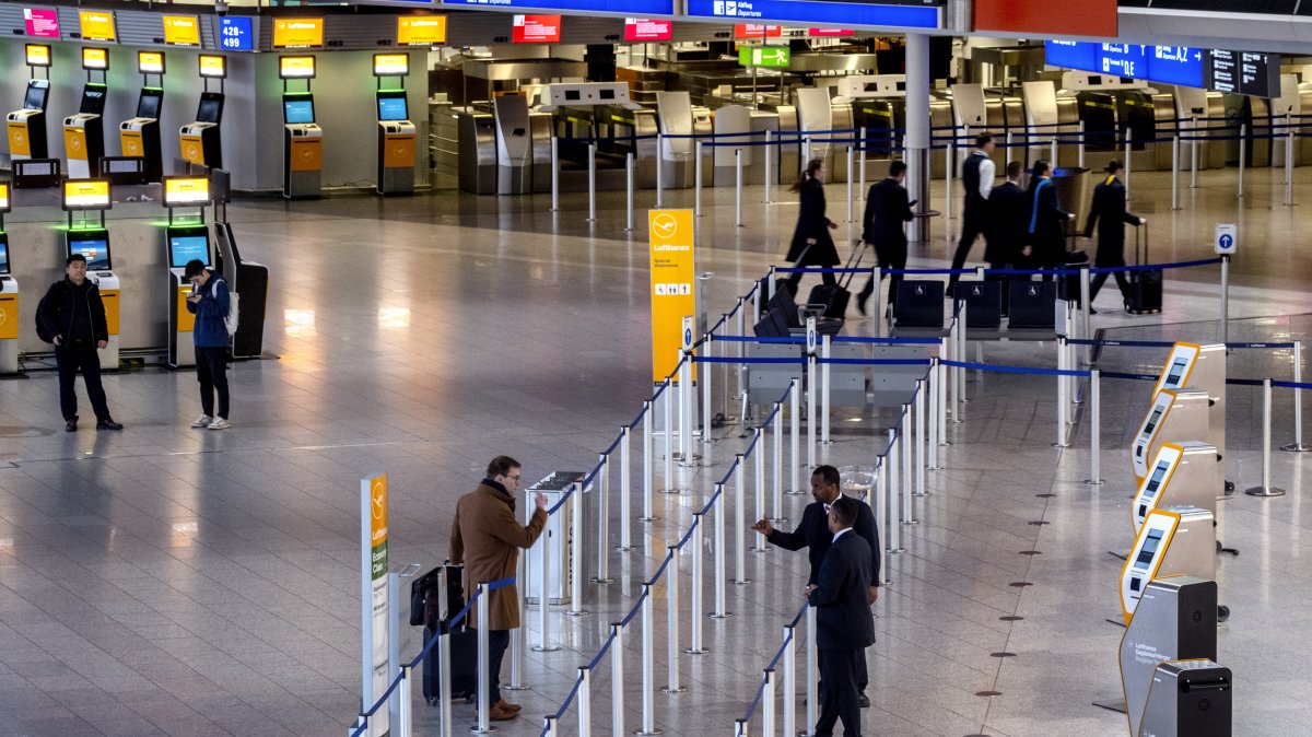 Passengers talk to airport staff in a terminal at the airport in Frankfurt, Germany, March 7, 2024. (AP File Photo)