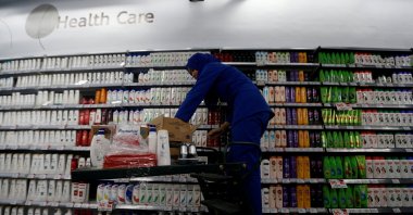 An employee of PT Unilever Indonesia arranges a health care rack at a Foodmart Fresh supermarket in Jakarta, Indonesia, Oct. 31, 2016. (Reuters Photo)