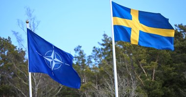 The NATO flag is raised next to the Swedish one at the Musko Naval base near Stockholm, Sweden, March 11, 2024. (Reuters Photo)
