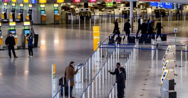 Passengers talk to airport staff in a terminal at the airport in Frankfurt, Germany, March 7, 2024. (AP File Photo)