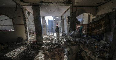A Palestinian girl inspects her family's destroyed house following an Israeli air strike on Deir Al Balah refugee camp, central Gaza Strip, Jan. 9, 2025. (EPA Photo)