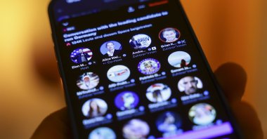 An illustration shows a person following an interview streamed on X between U.S. tech entrepreneur Elon Musk and Alternative for Germany (AfD) party and faction co-chairperson and top candidate for the federal election Alice Weidel, in Essen, Germany, Jan. 9, 2025. (EPA Photo)