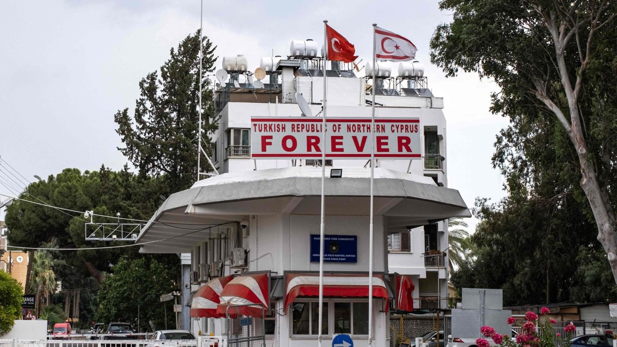 Flags of Türkiye and the Turkish Republic of Northern Cyprus (TRNC) fly above a checkpoint controlled by the TRNC leading to the U.N. buffer zone on the island, in the northern part of the divided capital Lefkoşa (Nicosia), Turkish Cyprus, July 11, 2024. (AFP Photo)