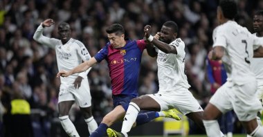 Barcelona's Robert Lewandowski (2nd L) fights for the ball against Real Madrid's Antonio Rudiger during a Spanish La Liga match at the Santiago Bernabeu stadium, Madrid, Spain, Oct. 26, 2024. (AP Photo)