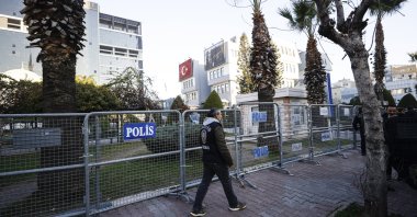 A police officer patrols along barricades set up outside the Akdeniz Municipality building following Mayor Hoşyar Sarıyıldız's detention in Mersin, Türkiye, Dec. 10, 2024. (AA Photo)
