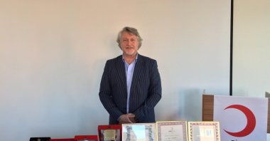 Tayfun Başdemir receives a special plaque for his 200th blood donation, Istanbul, Türkiye, Jan. 9, 2024. (AA Photo) 