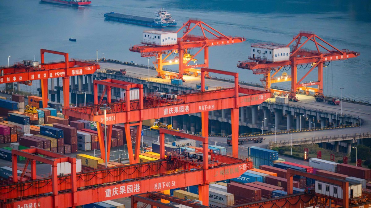 Cargo ships pass containers at the Port of Guoyuan, Chongqing, China, Jan. 11, 2025. (AFP Photo)