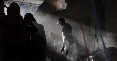 People search for their belongings amid the rubble of buildings destroyed in Israeli airstrikes in Gaza City, Palestine, Jan. 13, 2025. (AFP Photo)