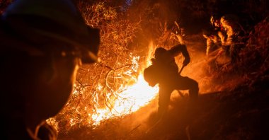 Firefighters extinguish a fire as the Palisades Fire in Los Angeles County, Los Angeles, California, U.S., Jan. 12, 2025. (Reuters Photo)