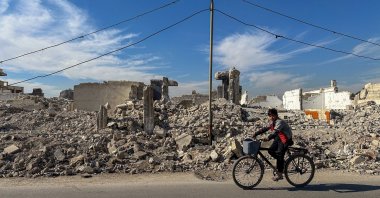 A man rides a bicycle near the completely destroyed al-Asali neighborhood in southern Damascus, Syria, Jan. 9, 2025. (EPA Photo)