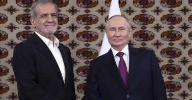 Russian President Vladimir Putin (R) and Iranian President Masoud Pezeshkian shake hands in Ashgabat, Turkmenistan, Oct. 11, 2024. (AP Photo)