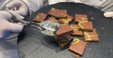 Service employees offer &quot;Dubai Chocolate&quot; in a Lindt shop to customers during the sell of limited bars of the Chocolate, in Aachen, Germany, Thursday, Nov. 14, 2024. (AP File Photo)