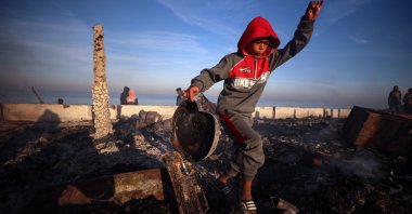 Palestinians inspect a destroyed coffee house following Israeli airstrikes near a makeshift displacement camp at the beach in Deir el-Balah in the central Gaza Strip on January 14, 2025. (Photo by AFP)