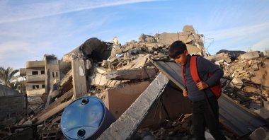 A boy walks past a destroyed building in the aftermath of an Israeli strike at Deir al-Balah in the central Gaza Strip, Jan. 15, 2025. (AFP Photo)