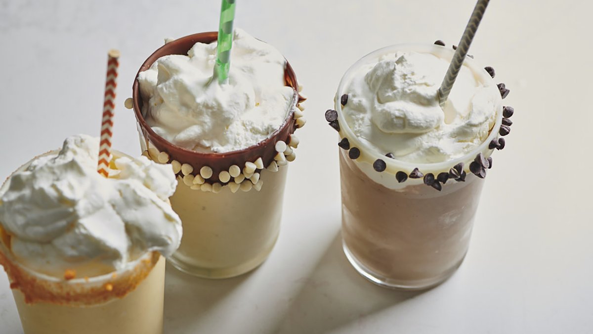 This 2019 image provided by Katie Workman shows leftover eggnog milkshakes in vanilla, chocolate and mango variations in New York, U.S. (AP Photo)