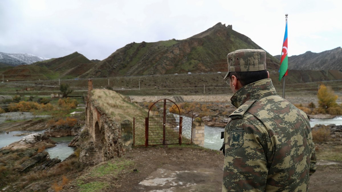 An Azerbaijani service member looks at the ancient Khodaafarin Bridge near the border with Iran in the area in Jabrayil District, Karabakh, Azerbaijan, Dec. 7, 2020. (Reuters File Photo)