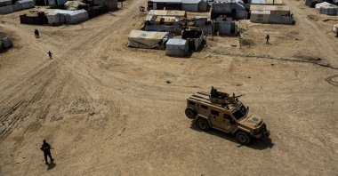 PKK/YPG terrorists patrol the al-Hol camp, which houses families of members of the Daesh terror group, Hassakeh province, Syria, April 19, 2023. (AP Photo)