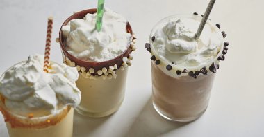 This 2019 image provided by Katie Workman shows leftover eggnog milkshakes in vanilla, chocolate and mango variations in New York, U.S. (AP Photo)