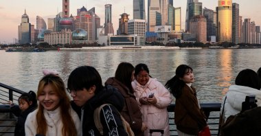 People hang out at The Bund as the financial district of Pudong is seen in the background in Shanghai, China, Jan. 16, 2025. (Reuters Photo)