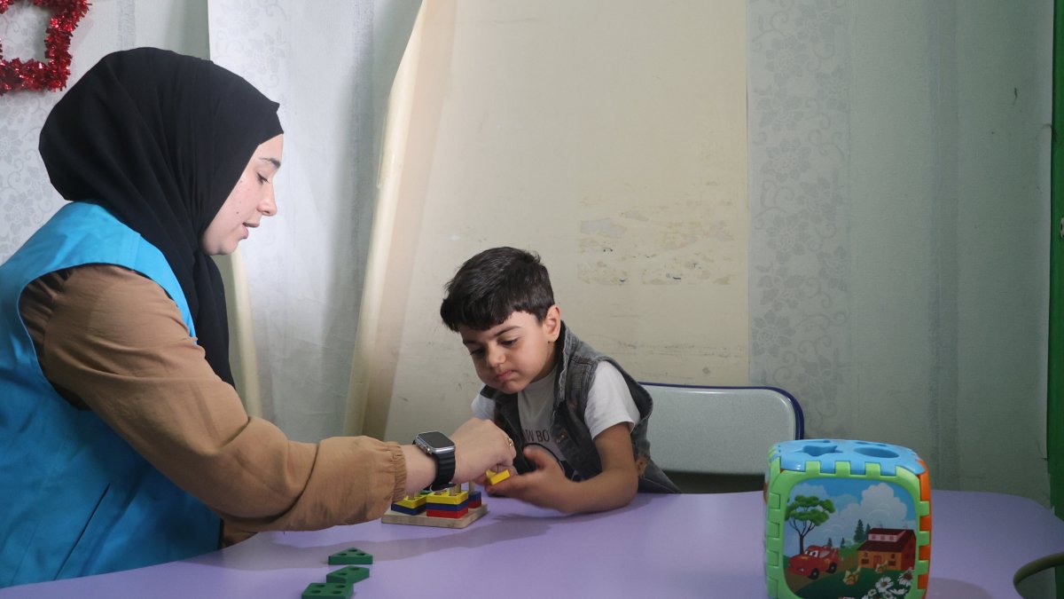A Türkiye Diyanet Foundation staff member cares for a war-affected child at the foundation&#039;s rehabilitation center in Azaz, Syria, Jan. 19, 2025. (AA Photo)