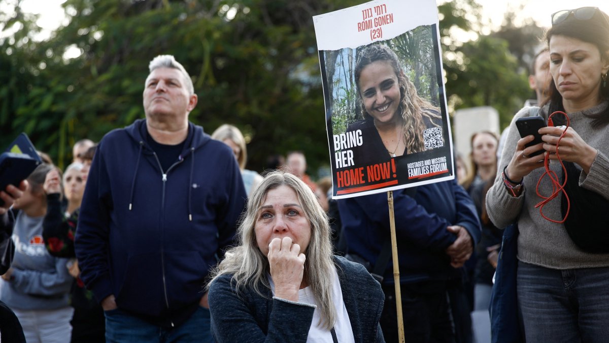 A woman reacts as people gather at a square to watch broadcasts related to the expected release of three female hostages held in Gaza, in Tel Aviv, Israel, Jan. 19, 2025. (Reuters Photo)