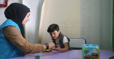 A Türkiye Diyanet Foundation staff member cares for a war-affected child at the foundation&#039;s rehabilitation center in Azaz, Syria, Jan. 19, 2025. (AA Photo)