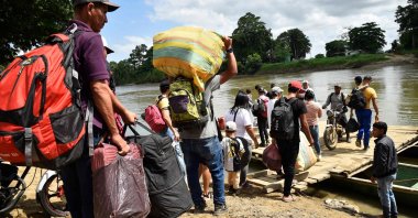 Displaced people from recent clashes between armed groups board canoes to cross the Tarra River, which divides Colombia and Venezuela, Norte de Santander department, Tibu, Colombia, Jan. 19, 2025. (AFP Photo)