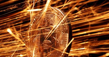 Sparks strike a representation of the cryptocurrency bitcoin in this illustration taken Nov. 24, 2024. (Reuters Photo)