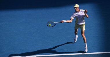 Italy&#039;s Jannik Sinner hits a return against Denmark&#039;s Holger Rune during their Australian Open match, Melbourne, Australia, Jan. 20, 2025. (AFP Photo)