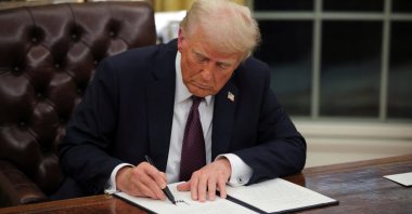 U.S. President Donald Trump signs documents as he issues executive orders and pardons for Jan. 6 defendants in the Oval Office at the White House, Washington, D.C., U.S., Jan. 20, 2025.  (Reuters Photo)