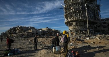 Internally displaced Palestinian people walk along a street among the rubble of destroyed buildings amid a cease-fire between Israel and Hamas, Rafah, Gaza Strip, Palestine, Jan. 20, 2025. (EPA Photo)