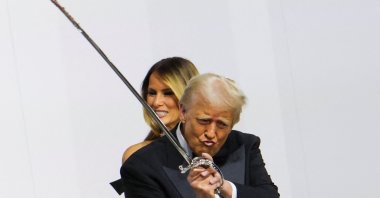 U.S. President Donald Trump gestures while holding a sword, near first lady Melania Trump, as they attend the Commander in Chief Ball in honor of his inauguration, Washington, U.S., Jan. 20, 2025. (Reuters photo)