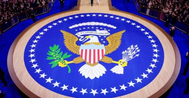 U.S. President Donald Trump arrives to dance with first lady Melania Trump at the Commander-in-Chief Ball runway, which has the traditional motto &quot;Out of many, one&quot; in Latin written on it, Washington, U.S., Jan. 20, 2025. (AFP Photo)