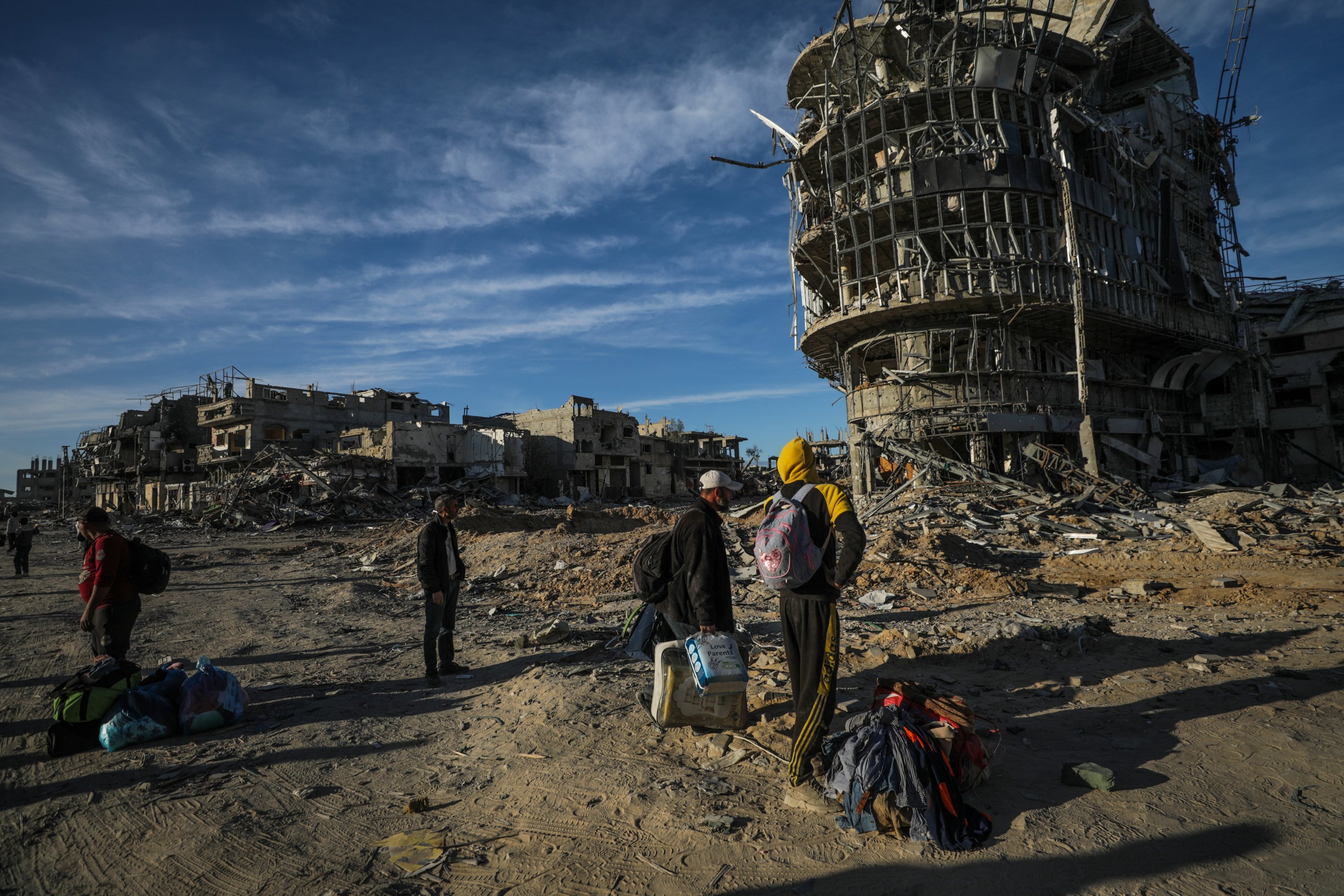 Internally displaced Palestinians walk along a street among the rubble of buildings destroyed in Israeli attacks, in Rafah, southern Gaza Strip, Jan. 20, 2025. (EPA Photo)