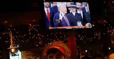 People watch and record the inauguration ceremony of U.S. President Donald Trump at a watch party in New York City, U.S., Jan. 20, 2025. (AFP Photo)