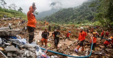 Rescue teams use high-pressure water to search for victims of a landslide in Kasimpar Village, Central Java, Indonesia, Jan. 22, 2025. (AFP Photo)