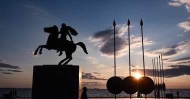 People walk next to the statue of Alexander the Great at sunset in the northern Greek city of Thessaloniki, on Dec. 28, 2024. (AFP File Photo)