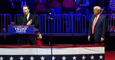 U.S. President-elect Donald Trump (R) looks on as SpaceX and Tesla CEO Elon Musk speaks at a MAGA victory rally at Capital One Arena, Washington, U.S., Jan. 19, 2025. (AFP Photo)