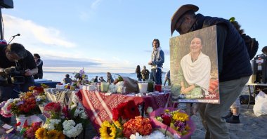 Photo of Ezgi Eygi hangs next to flowers at a vigil, Seattle, U.S., Sept. 11, 2024. (AP Photo)