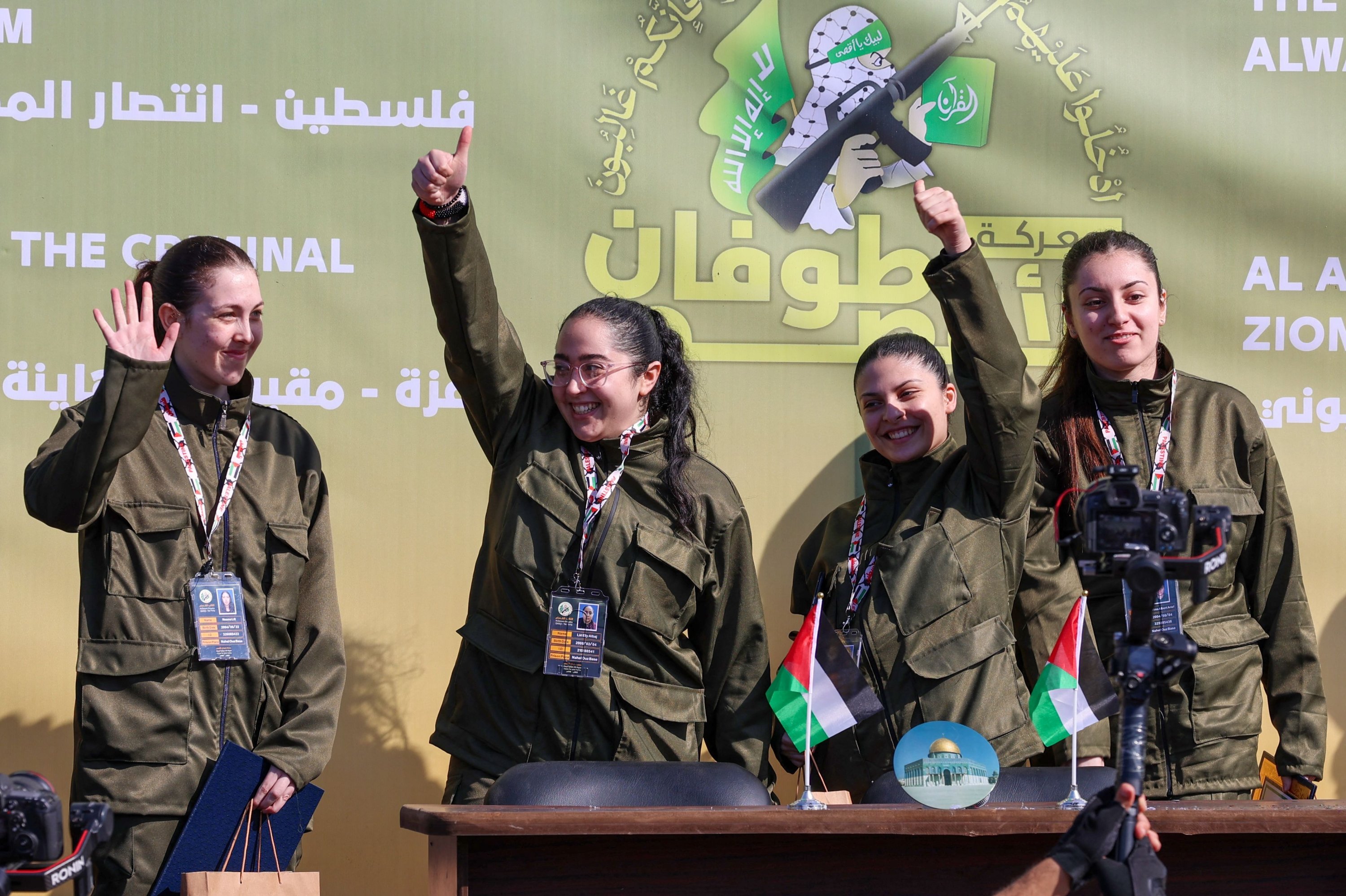 (From L-R) Four Israeli hostages, Naama Levy, Liri Albag, Daniella Gilboa and Karina Ariev, wave on a stage before Hamas members hand them over to a team from the Red Cross in Gaza City, Palestine, Jan. 25, 2025. (AFP Photo)