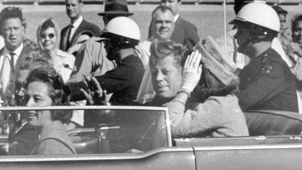President John F. Kennedy waves from his car in a motorcade in Dallas, with first lady Jacqueline Kennedy (R), Nellie Connally (2nd L) and her husband, Texas Gov. John Connally (far L), Nov. 22, 1963. (AP Photo)