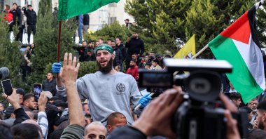 A Palestinian prisoners released by Israel reacts while being carried on people's shoulders in Ramallah, occupied West Bank, Jan. 25, 2025. (AFP Photo)