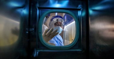 A medical staff member gestures inside an isolation ward at Red Cross Hospital in Wuhan, China, March 10, 2020. (AFP Photo)