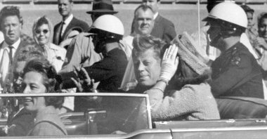 President John F. Kennedy waves from his car in a motorcade in Dallas, with first lady Jacqueline Kennedy (R), Nellie Connally (2nd L) and her husband, Texas Gov. John Connally (far L), Nov. 22, 1963. (AP Photo)