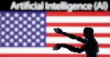 The words "AI" and "Artificial Intelligence," a miniature robot and a U.S. flag are seen in this illustration taken Dec. 21, 2023. (Reuters Photo)