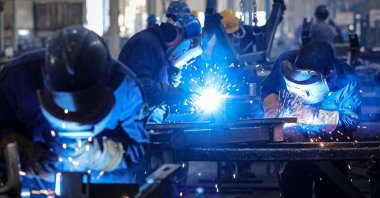 Employees weld parts at a factory producing mining equipment in Huaibei, in eastern China's Anhui province, Jan. 9, 2025. (AFP Photo)