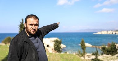 Ibrahim Bilal from a Silayip Turkmen village points at a strip of land with palaces belonging to the ousted Assad regime, Latakia, Syria, Jan. 16, 2025. (AA Photo)