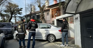 Police officers stand outside Ayşe Barım&#039;s home as they search for evidence following her detention, Istanbul, Türkiye, Jan. 24, 2025. (AA Photo)
