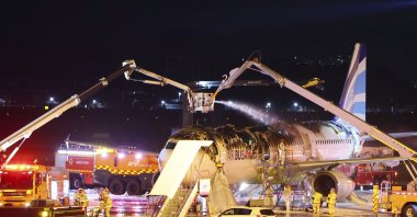 Firefighters work to extinguish a fire on an Air Busan airplane at Gimhae International Airport in Busan, South Korea, Jan. 28, 2025. (AP Photo)